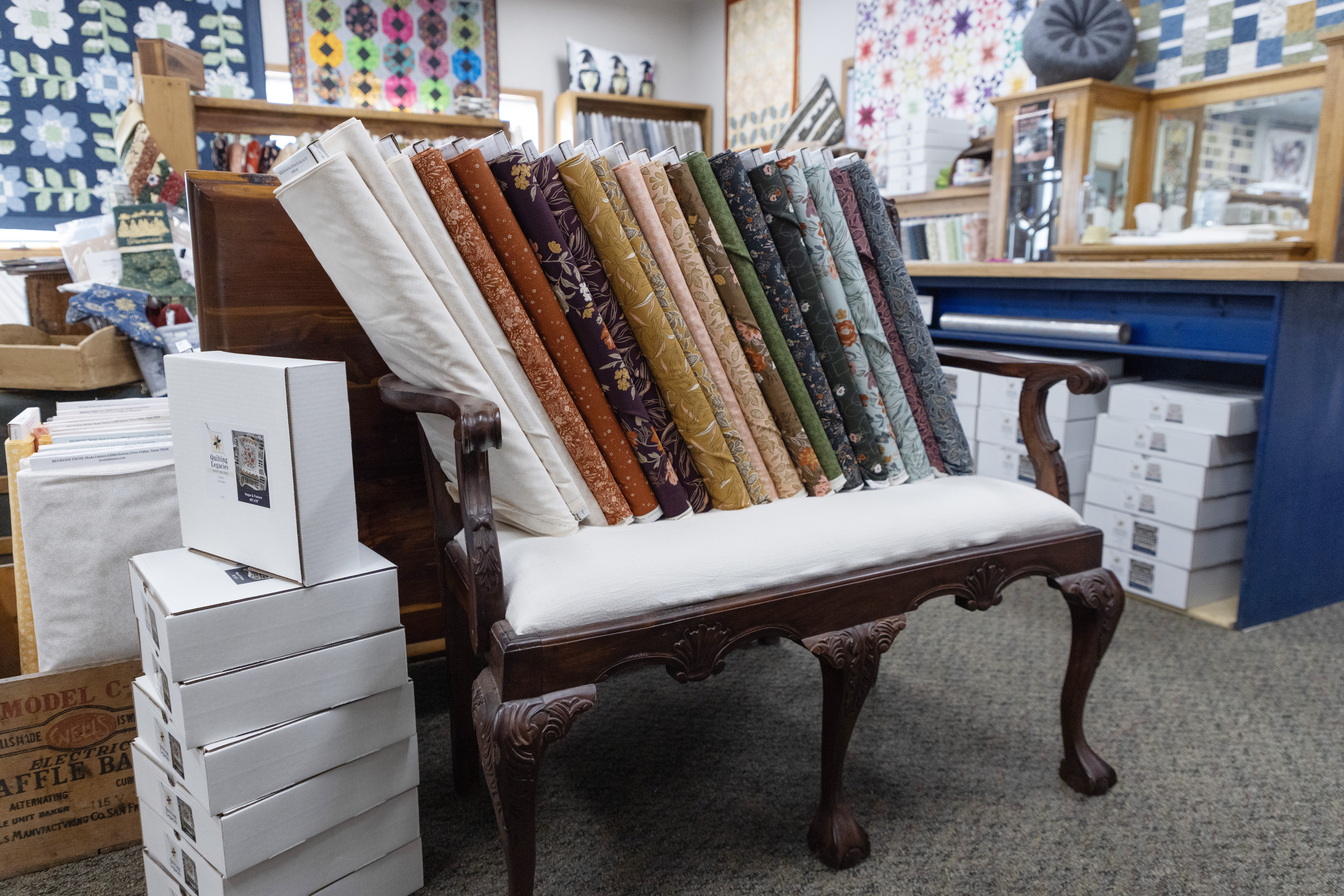 Various bolts of fabric on a bench in a quilt shop